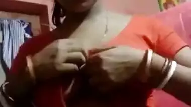 Aroused Desi wife slowly takes red top off to expose boobs for XXX fans
