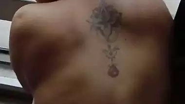 Lady fucks in front of a transparent glass in Indian porn