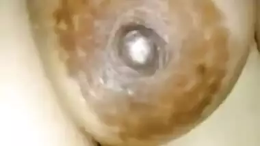 Indian slut sits in front of camera happily baring saggy XXX boobs